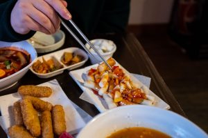Chopsticks grabbing Tteoktwigim at Comon 꼬몽 Restaurant Verdun