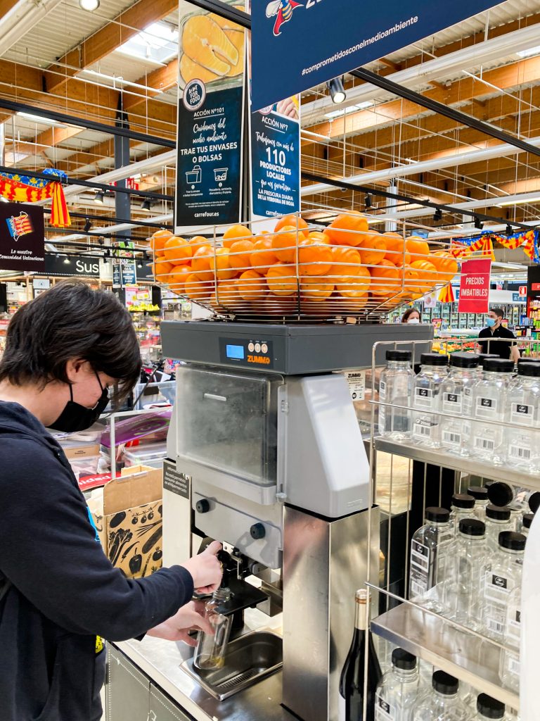 Fresh orange juice at Carrefour Market in Valencia, Spain - Best Things To Do - Jeff On The Road