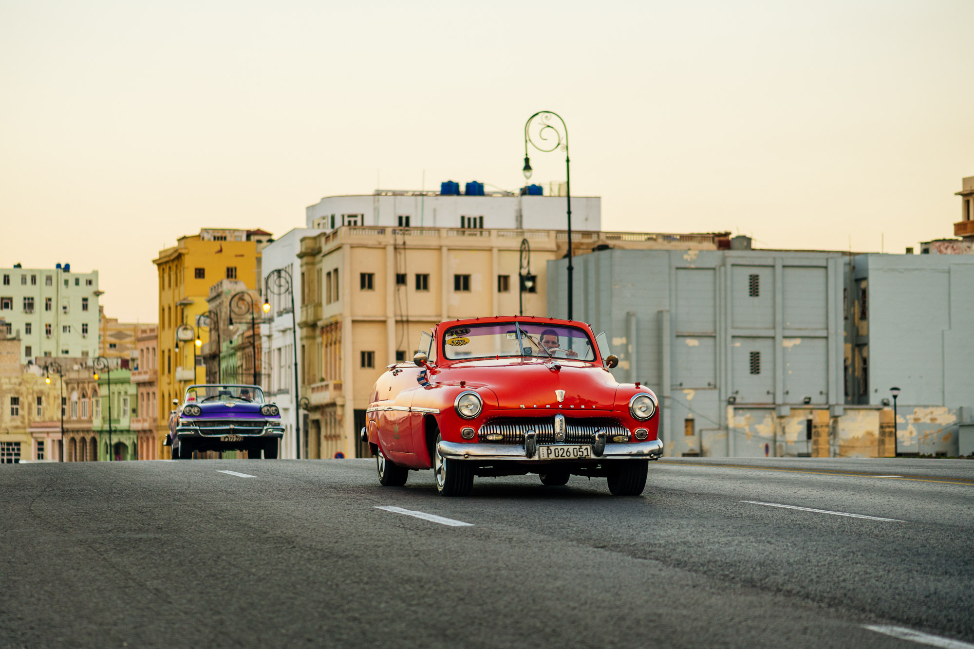Vintage american car cuising down the Malecon at sunset - Havana Best Things To Do - Cuba