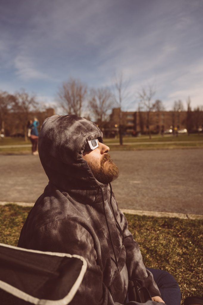 My partner Jérémie watching the sun during Solar Eclipse Photography Montreal 2024